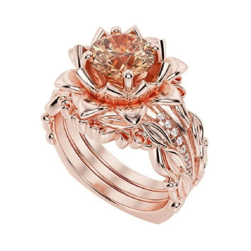 Women's geometric alloy ring with rose motif and zircon inlay, shown in rose gold, black rhinestone, and pink diamond electroplated finishes.