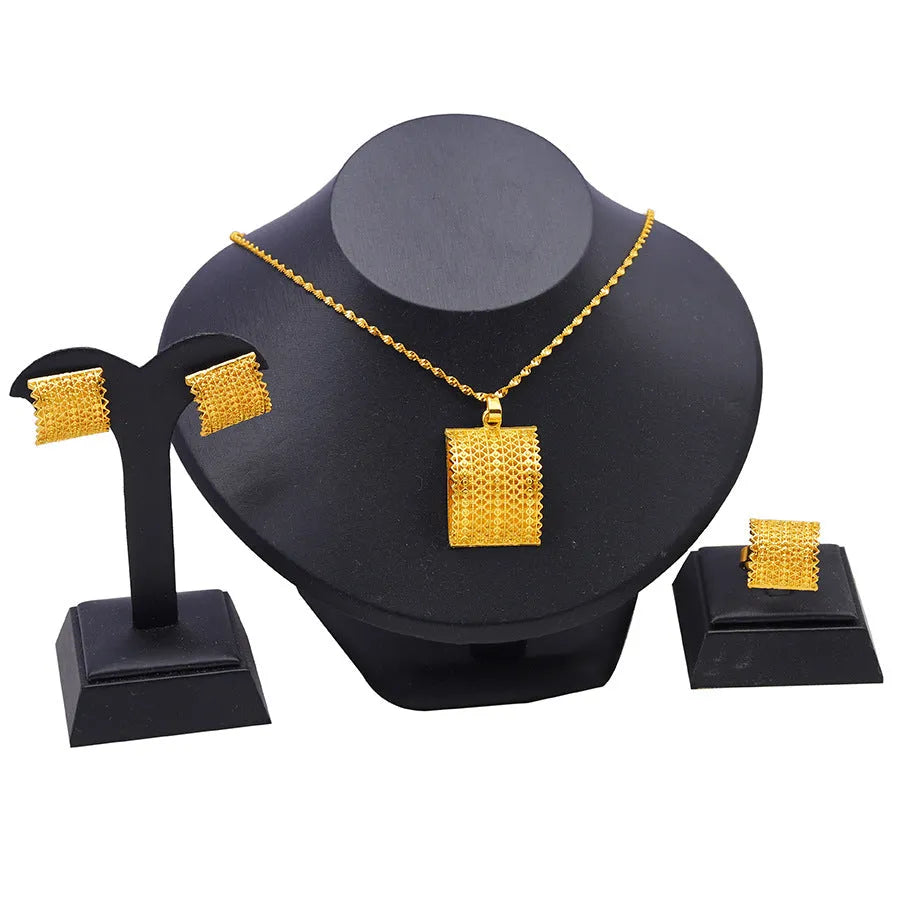 Gold tone wedding jewellery set showing necklace, earrings and ring on display
