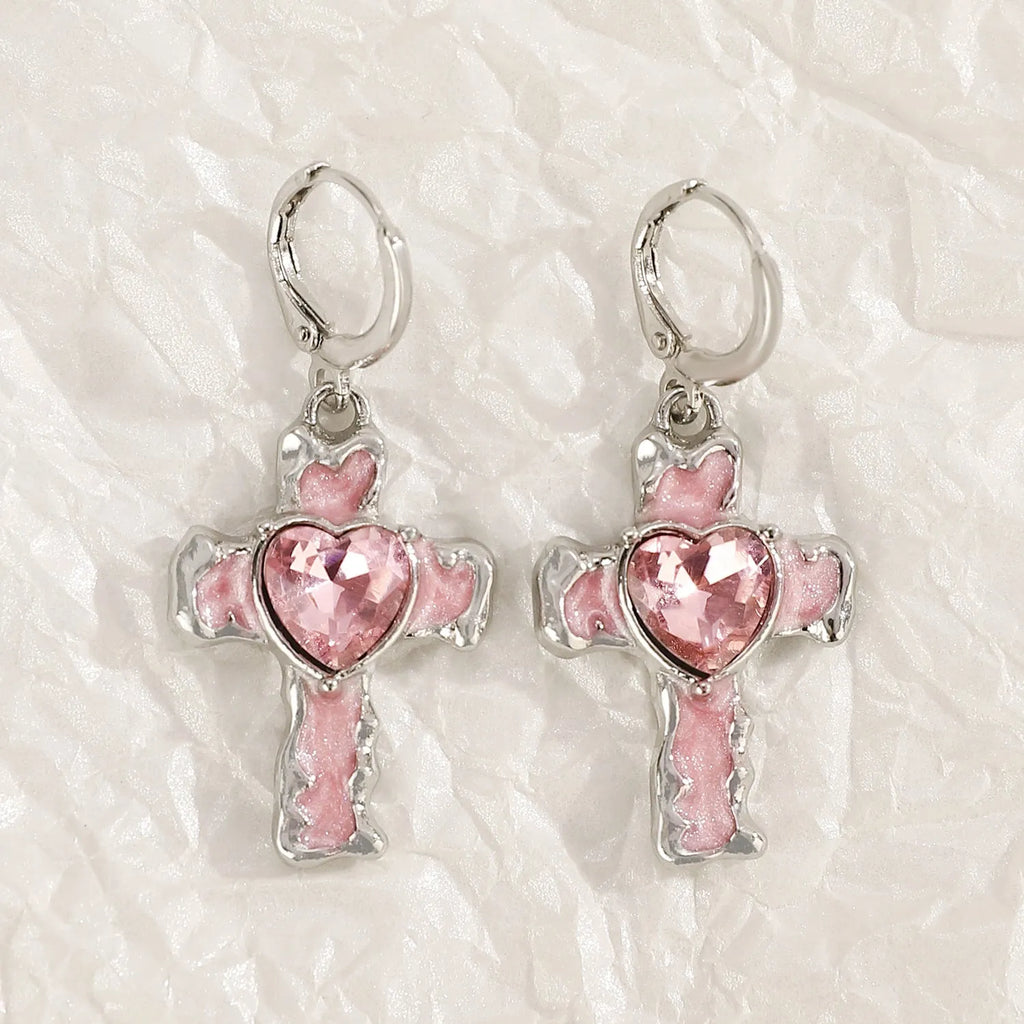 Women's alloy earrings with cross, crystal and character designs in white, black and silver colour variations