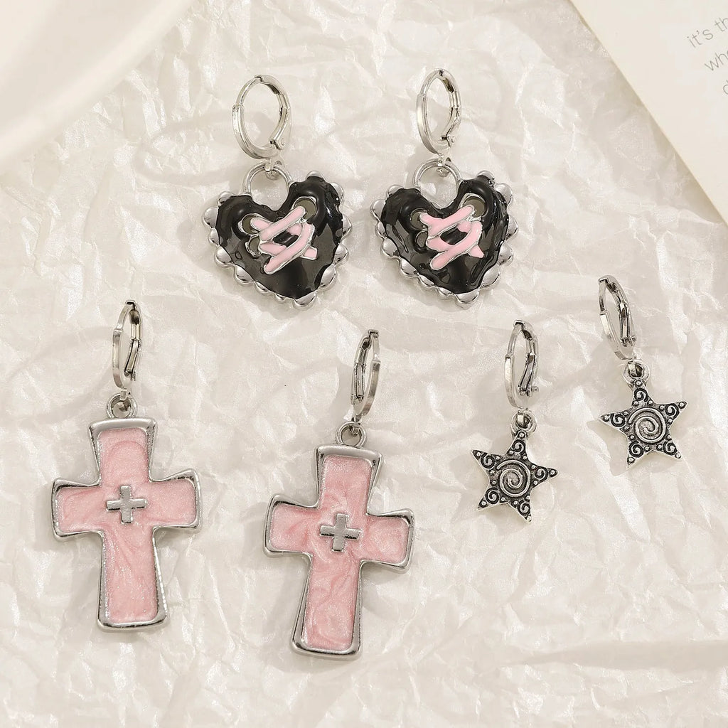 Women's alloy earrings with cross, crystal and character designs in white, black and silver colour variations