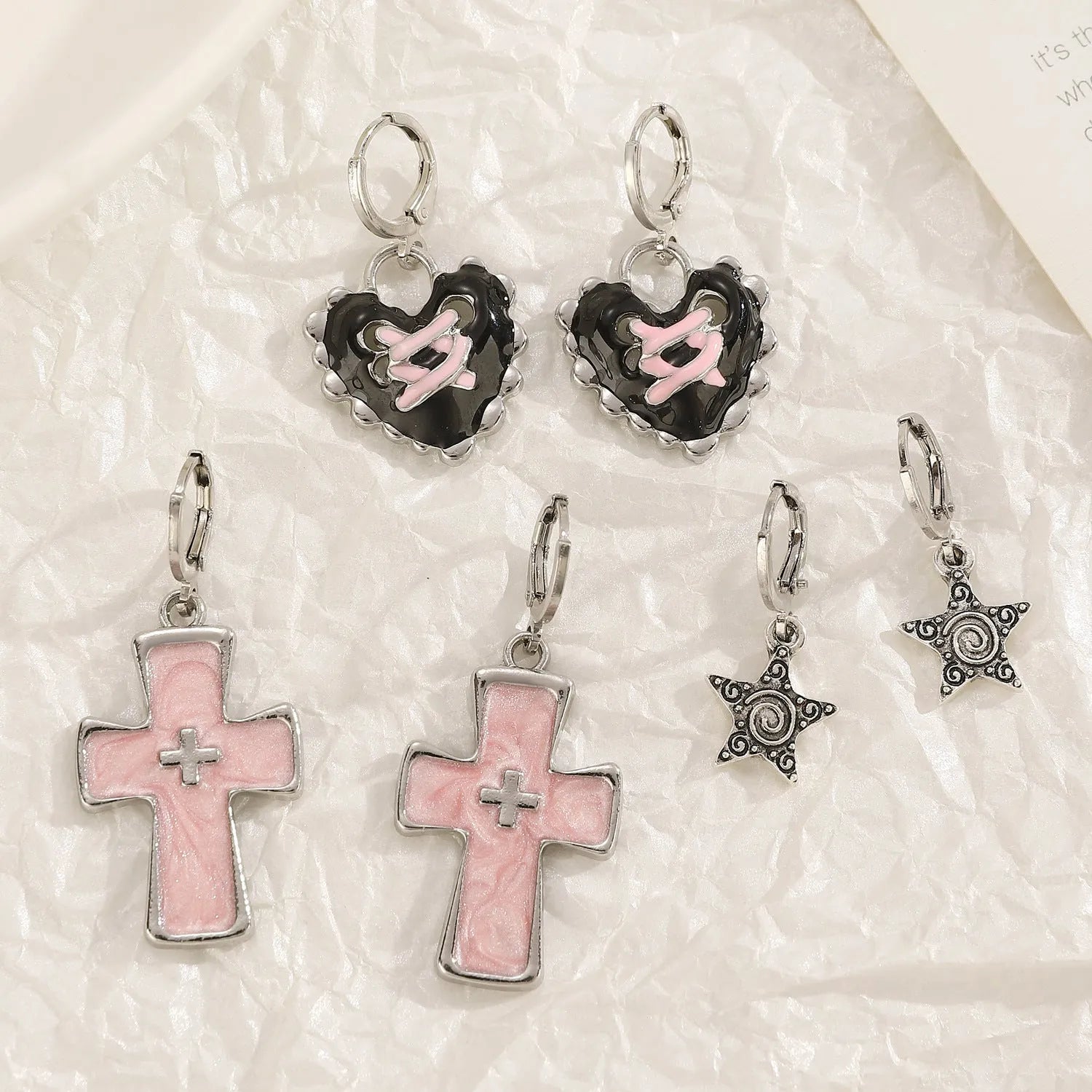 Women's alloy earrings with cross, crystal and character designs in white, black and silver colour variations