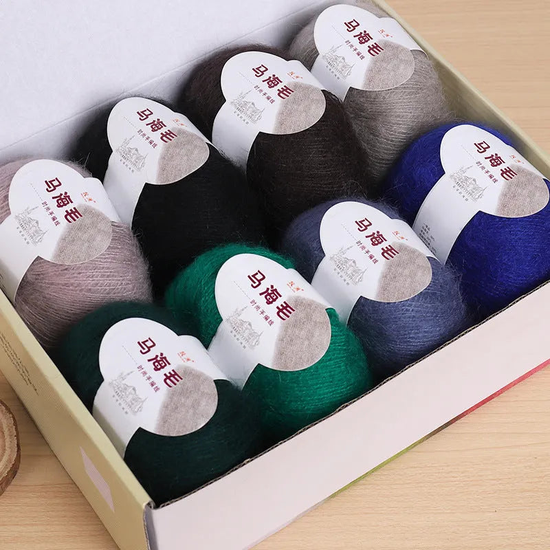 Ball of mohair wool for DIY scarf knitting kit in one of 34 colours including blue, pink, green, grey, and black.