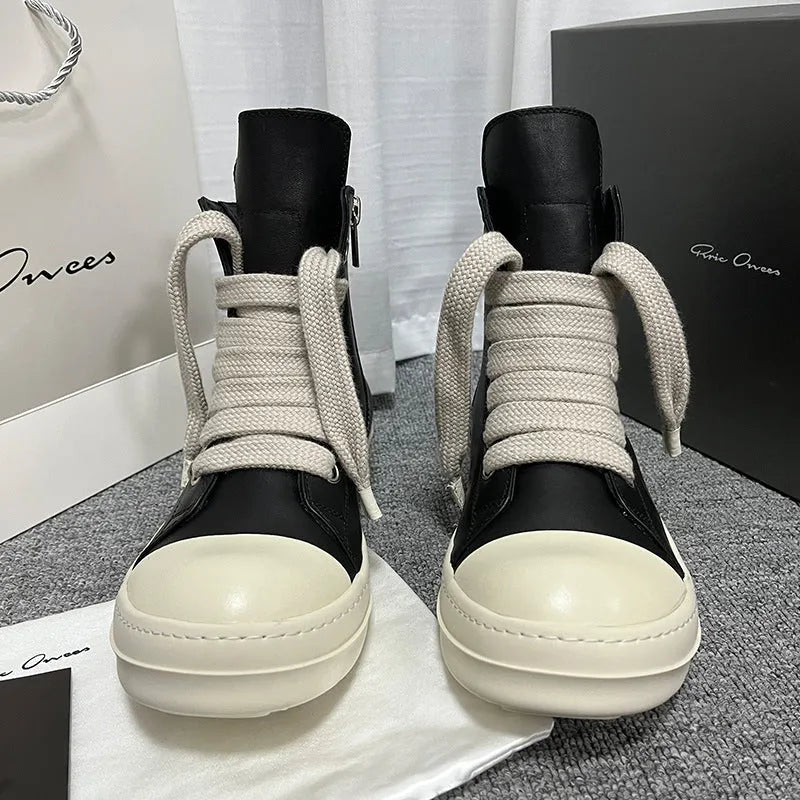 Black high-top leather sneakers with side zipper on a white background