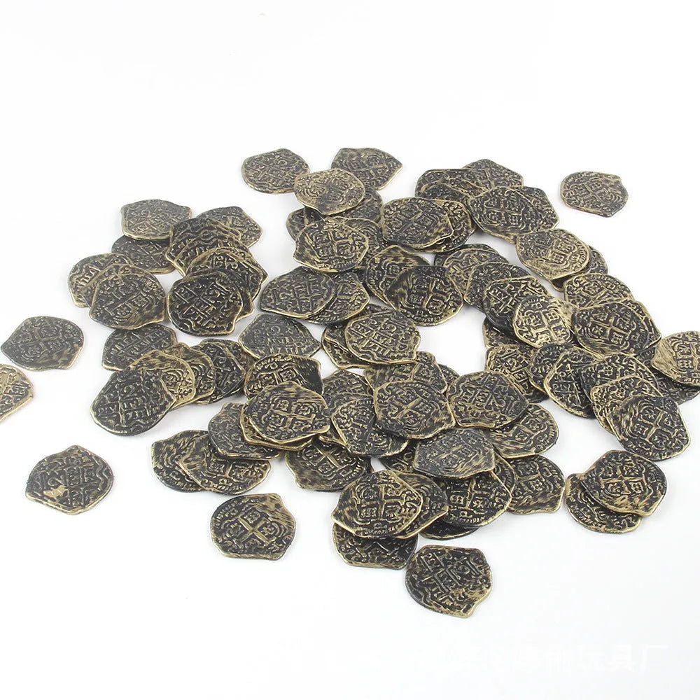 Set of 100 plastic Roman coins with electroplated bronze, gold, or silver finish, shown in hand for scale.
