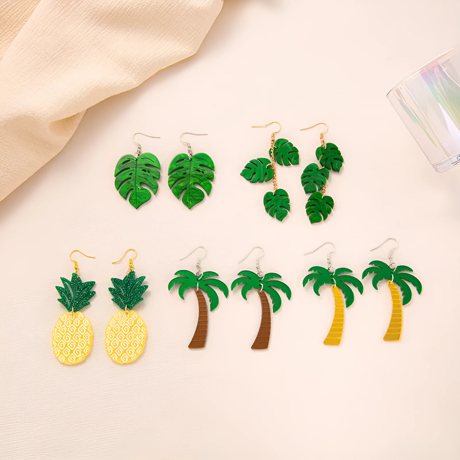 Alloy drop earrings with a blue acrylic artocarpus heterophyllus design and hook fastening.