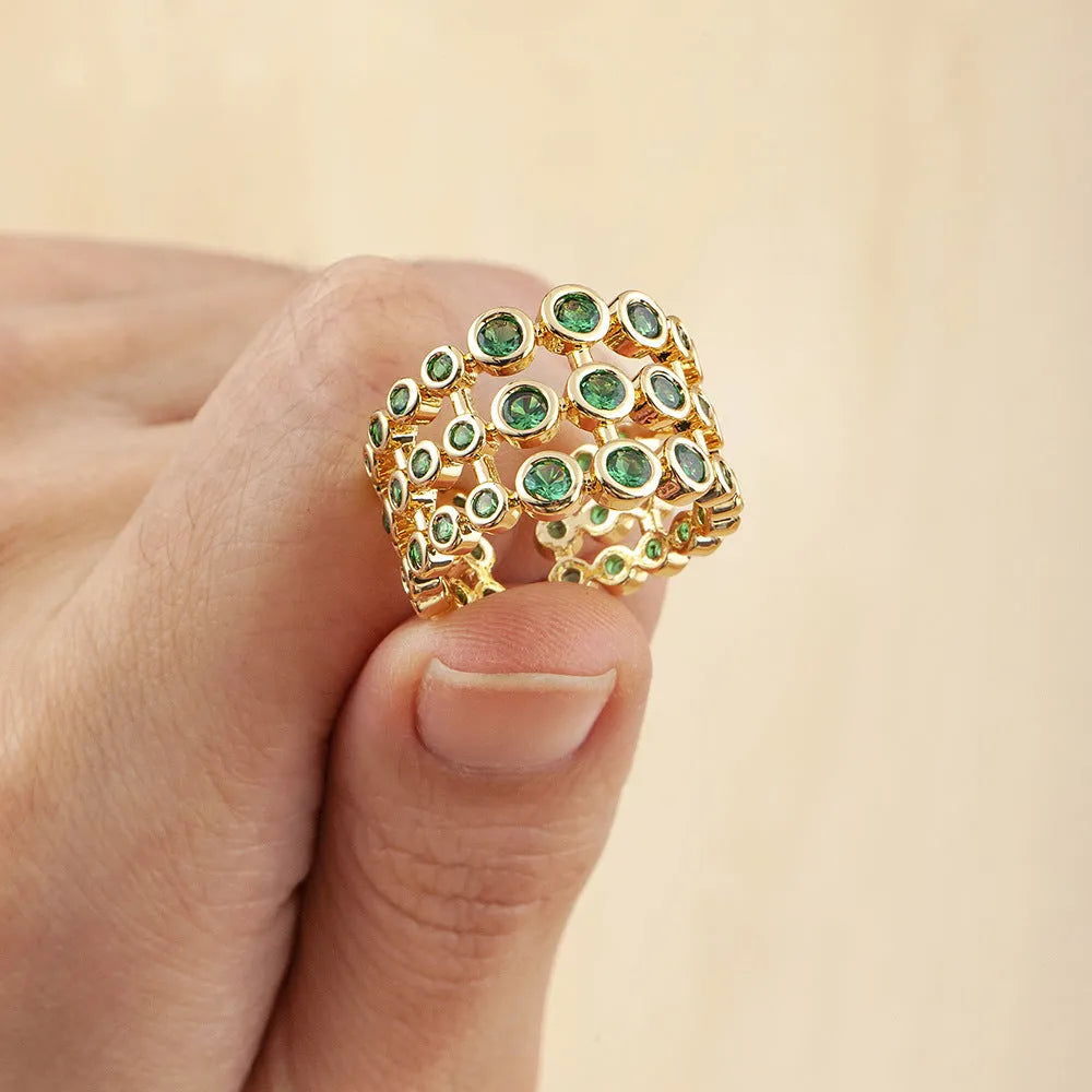 Copper ring with 18K gold plating showing three-layer exaggerated design with zircon stones