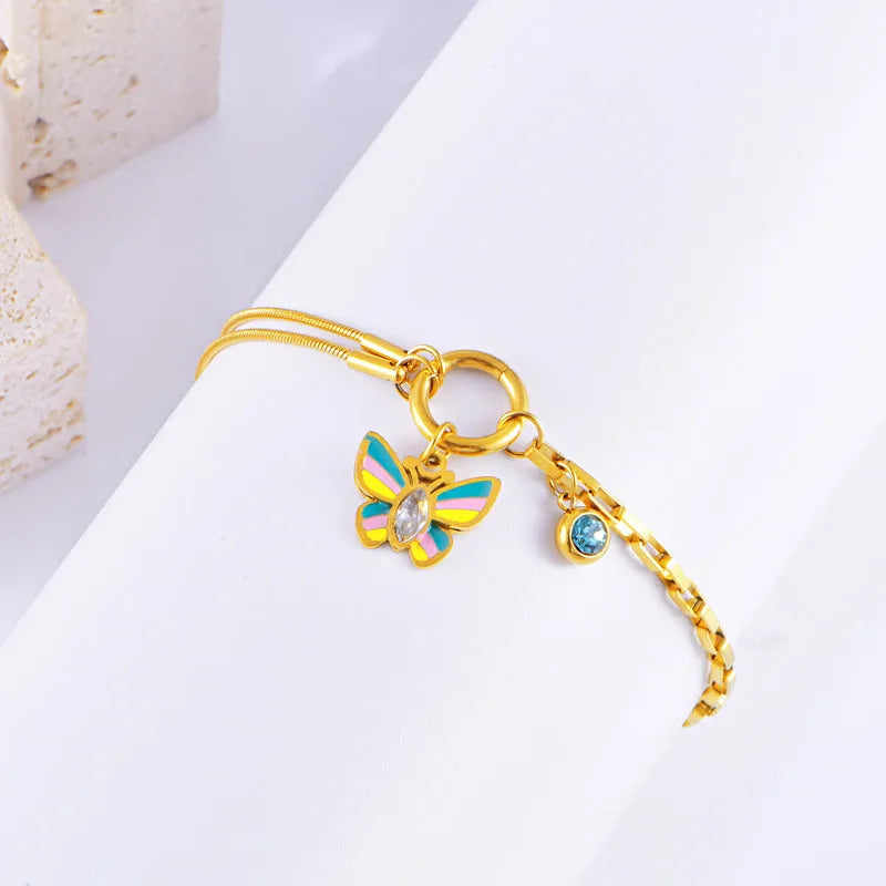 Gold titanium steel butterfly necklace and bracelet set with colourful epoxy detailing on animal pendant