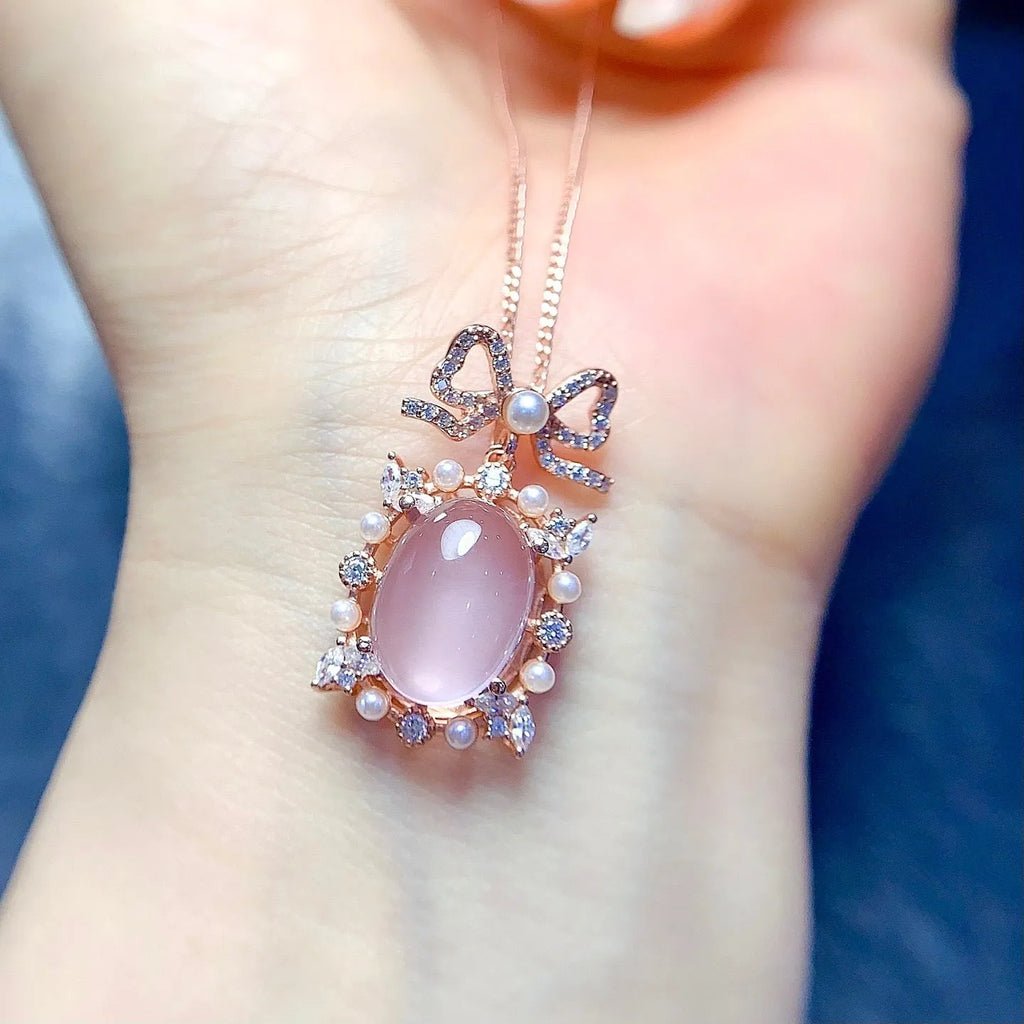 Rose gold plated geometric pendant with pink rose quartz stone on a silver chain.