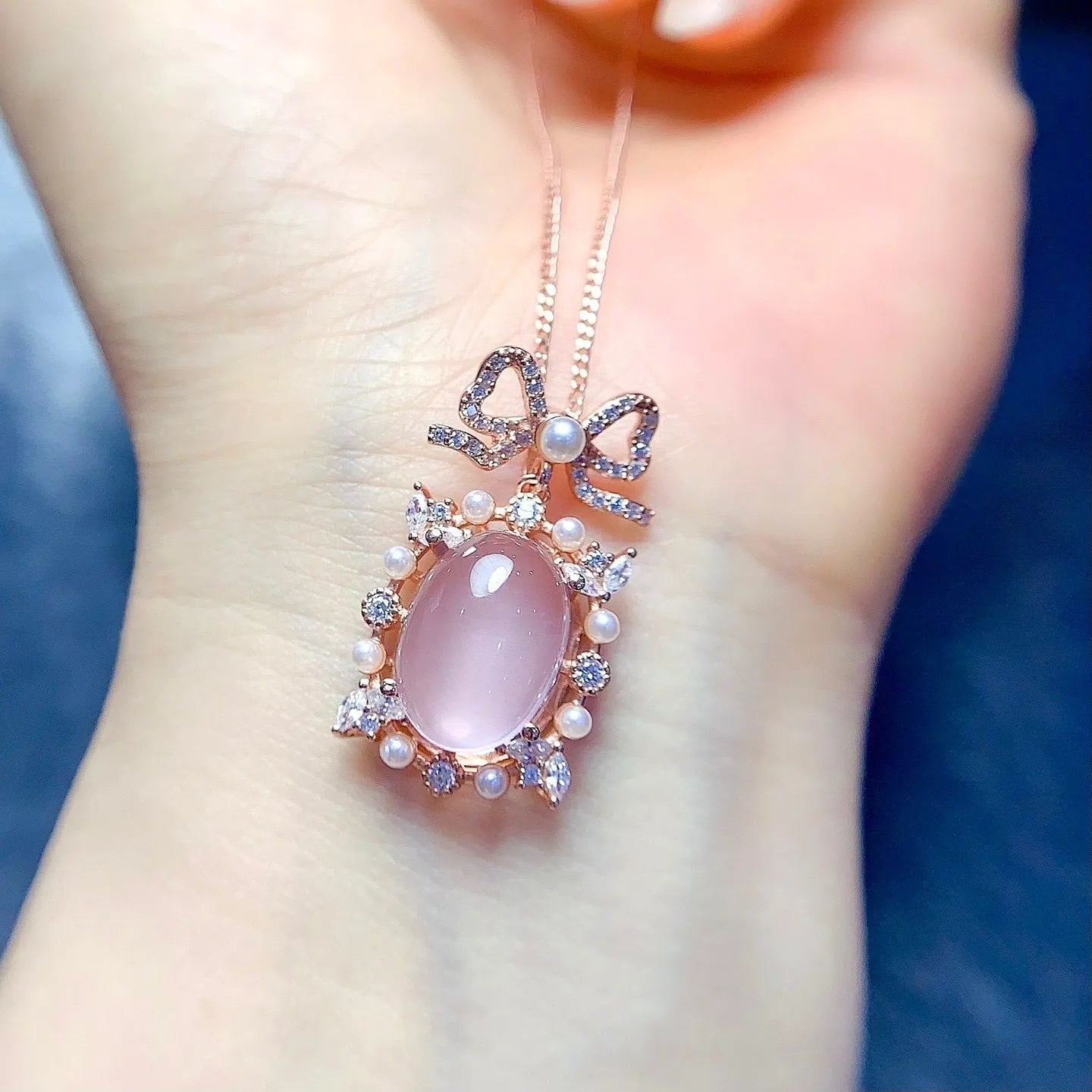 Rose gold plated geometric pendant with pink rose quartz stone on a silver chain.