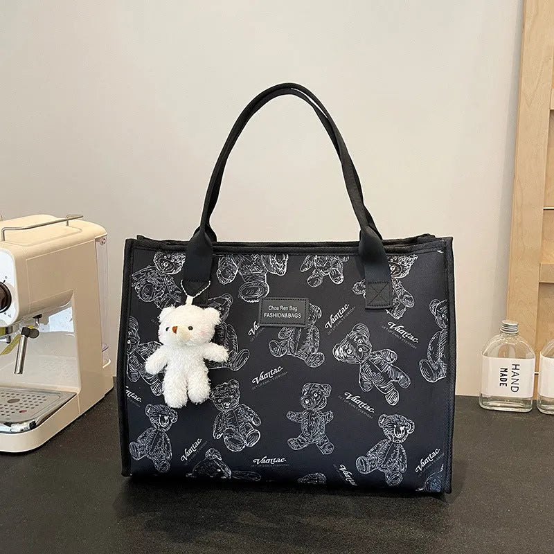 Women's black and white rhombus print canvas tote bag with horizontal square shape and shoulder strap