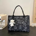 Women's black and white rhombus print canvas tote bag with horizontal square shape and shoulder strap