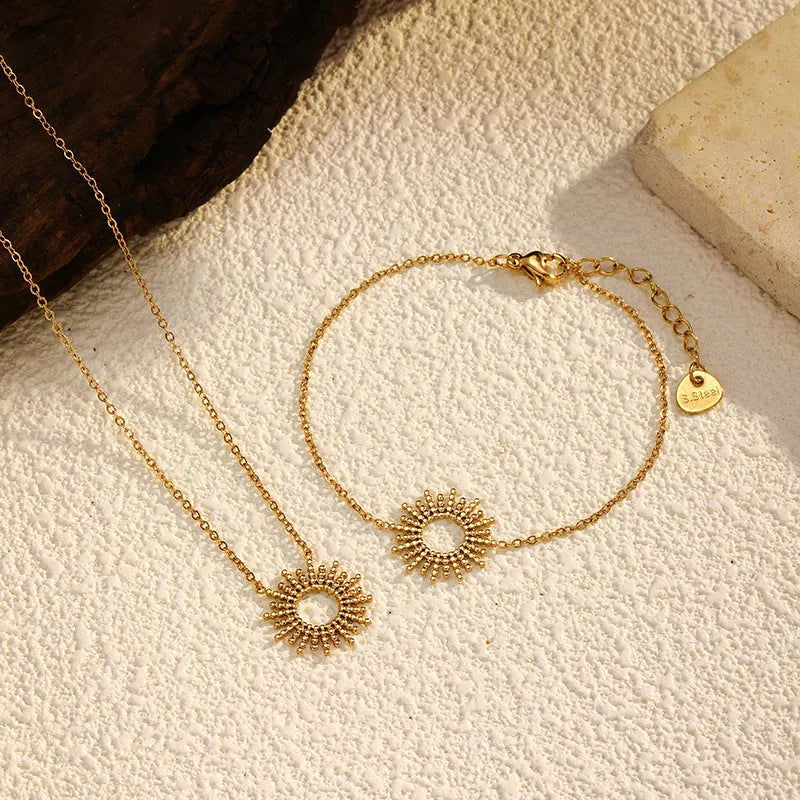 Gold-coloured jewellery set with matching geometry pendant necklace and chain bracelet