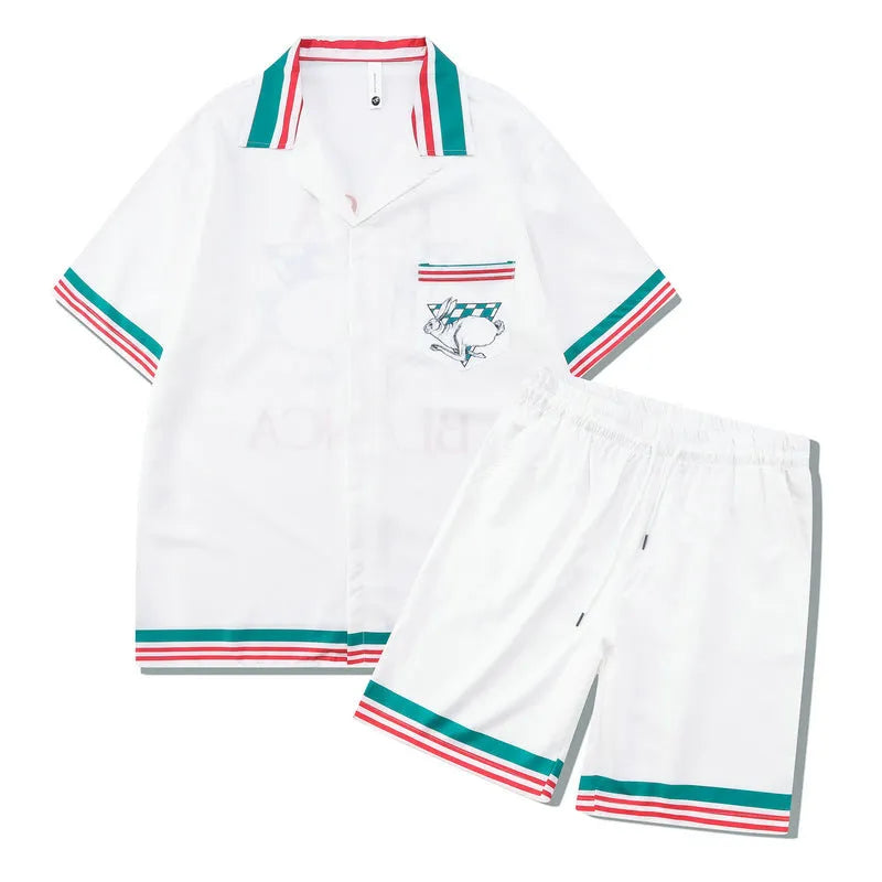 Men's plaid short-sleeve shirt and trouser beach outfit on a hanger.