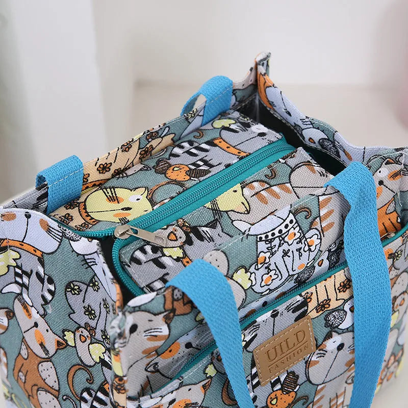 Women's large printed canvas handbag with aluminium base in floral and animal print designs.