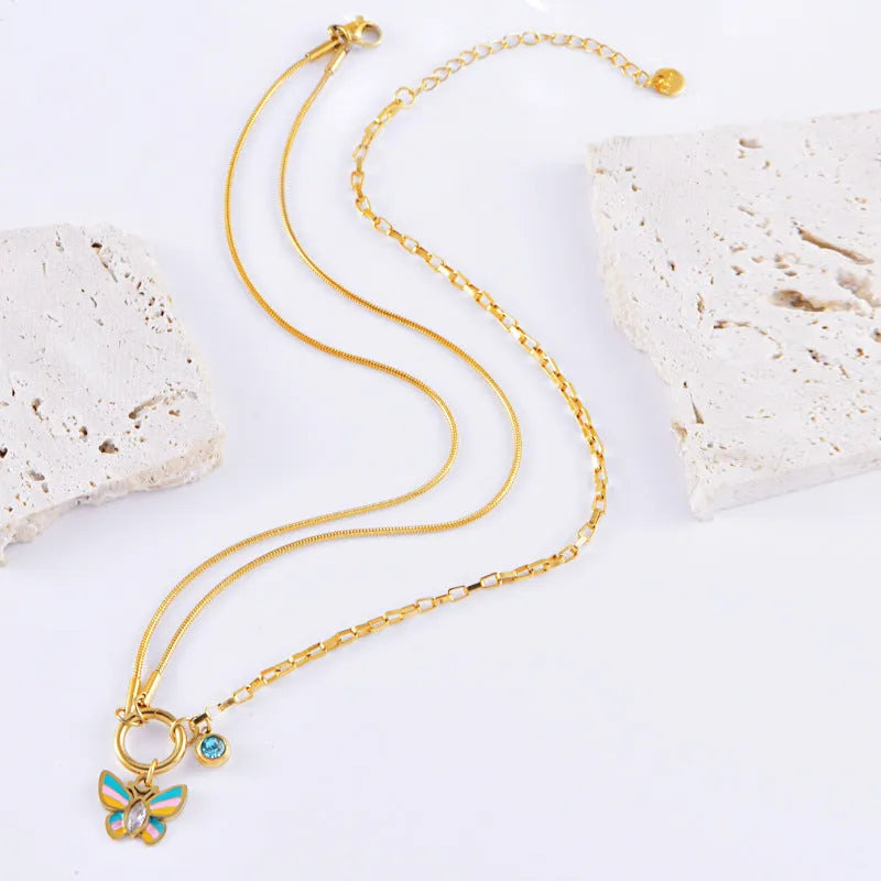 Gold titanium steel butterfly necklace and bracelet set with colourful epoxy detailing on animal pendant