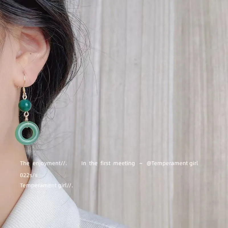 Pair of green Chinese style peace buckle geometric earrings with gold plating.
