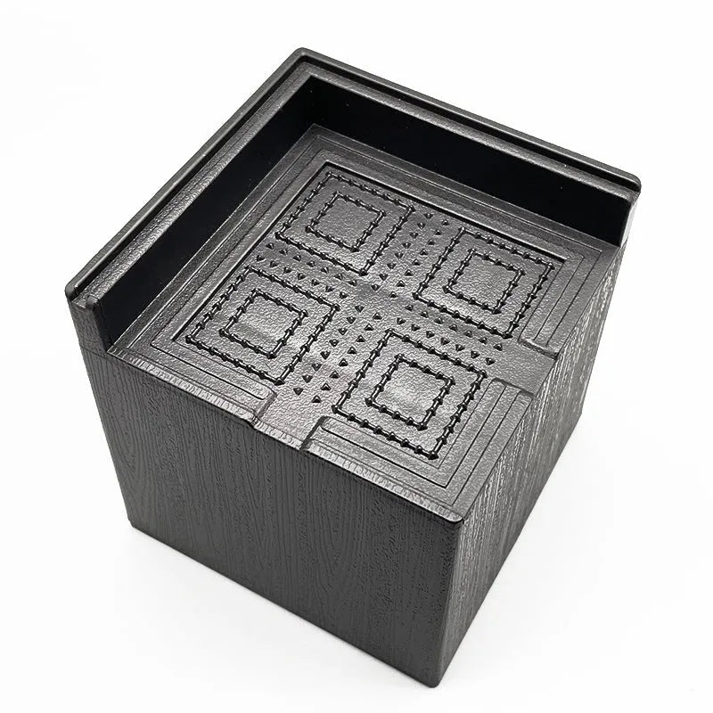 Four black plastic bed feet height adjustment mats for furniture levelling