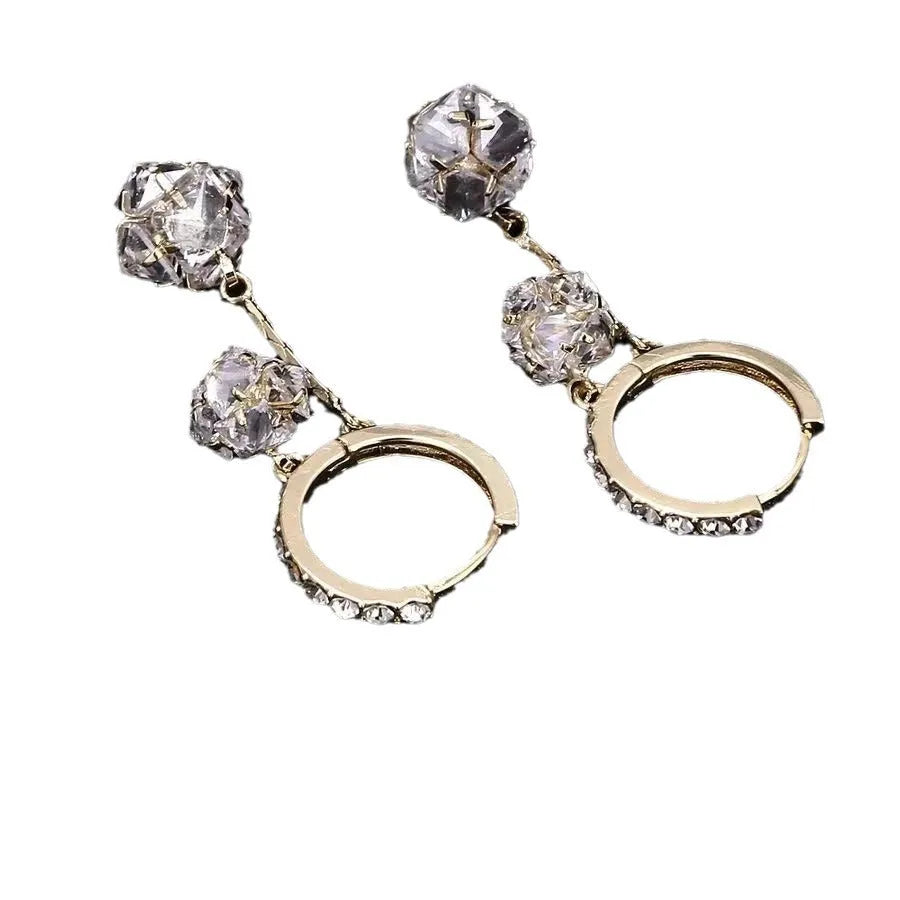 Silver women's clip-on drop earrings with a tassel ball and rhinestone ball pendant.