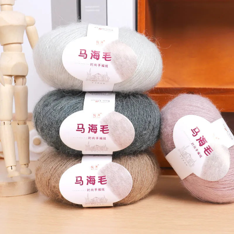 Ball of mohair wool for DIY scarf knitting kit in one of 34 colours including blue, pink, green, grey, and black.