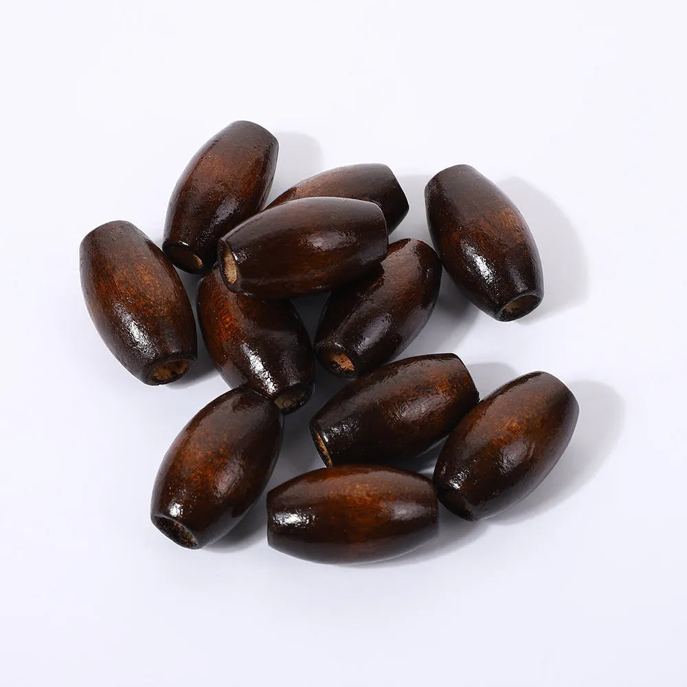 Dark coffee coloured oval wooden bead with raised M-shaped design, showing 6mm centre hole.