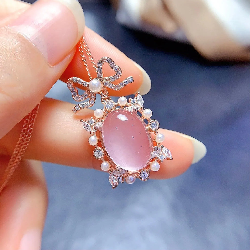 Rose gold plated geometric pendant with pink rose quartz stone on a silver chain.