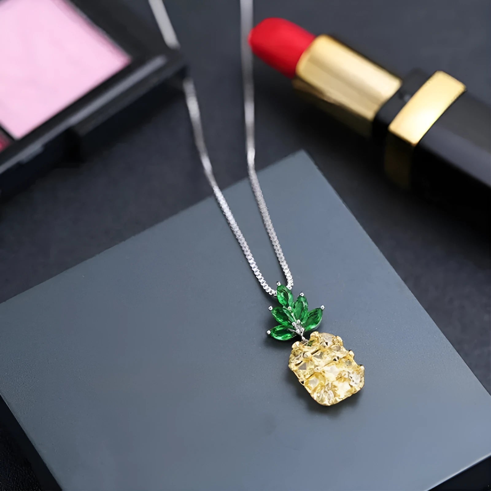 Silver geometric pineapple and diamond pendant necklace on a model.