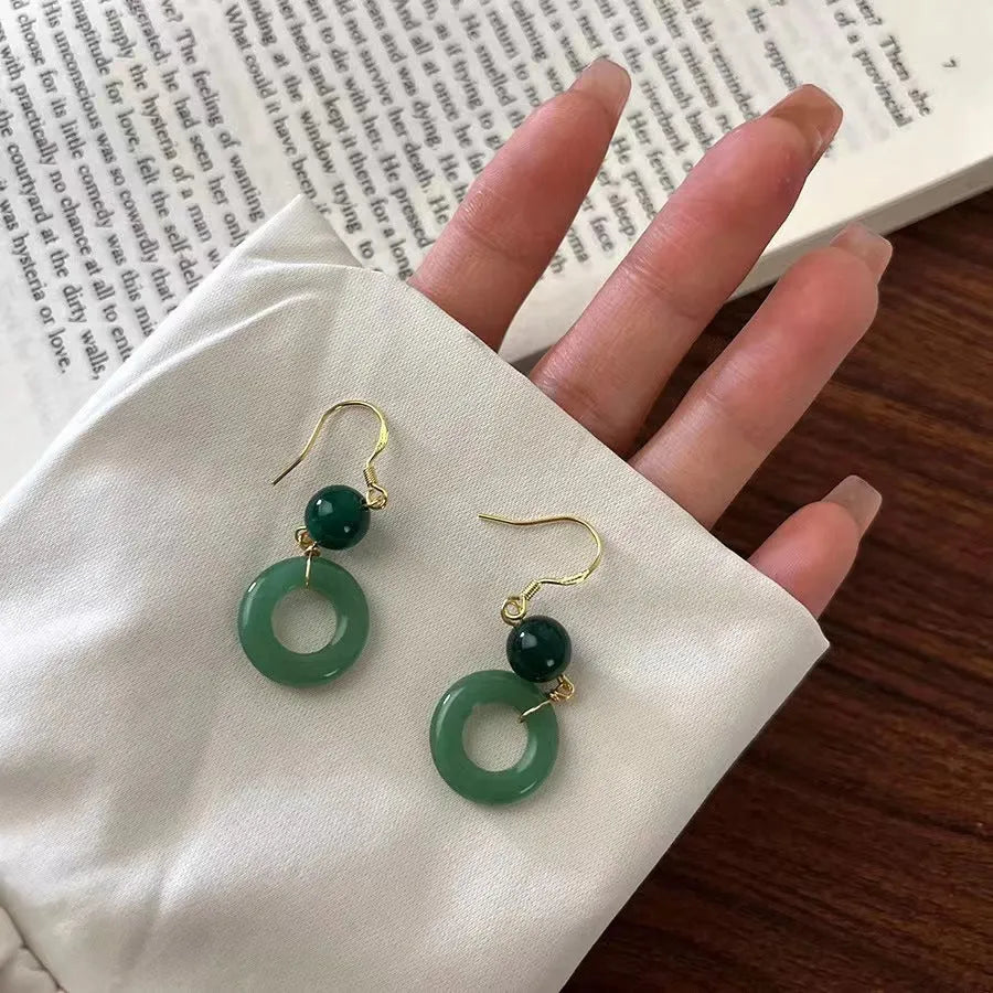 Pair of green Chinese style peace buckle geometric earrings with gold plating.
