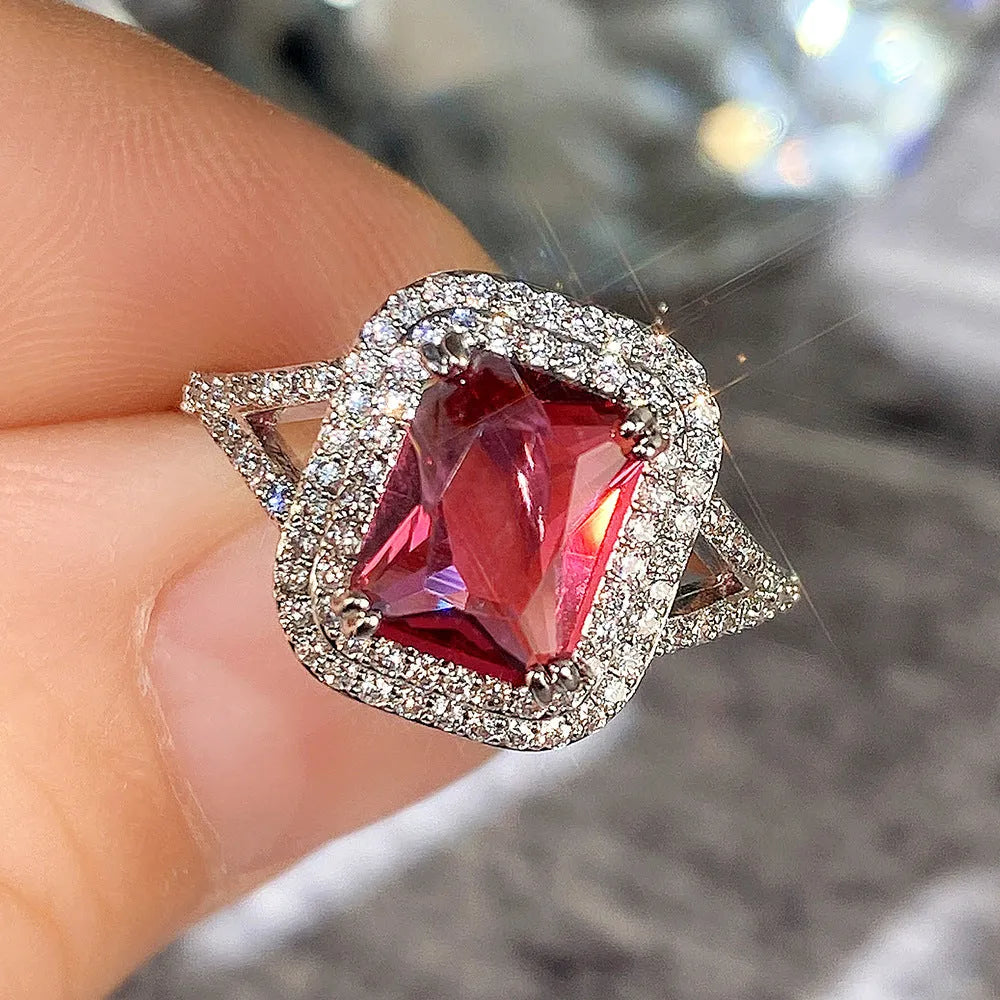 Red copper women's ring with square geometric face and clear rhinestones.