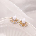 Silver fan-shaped geometric drop earrings with rhinestones on a white background.