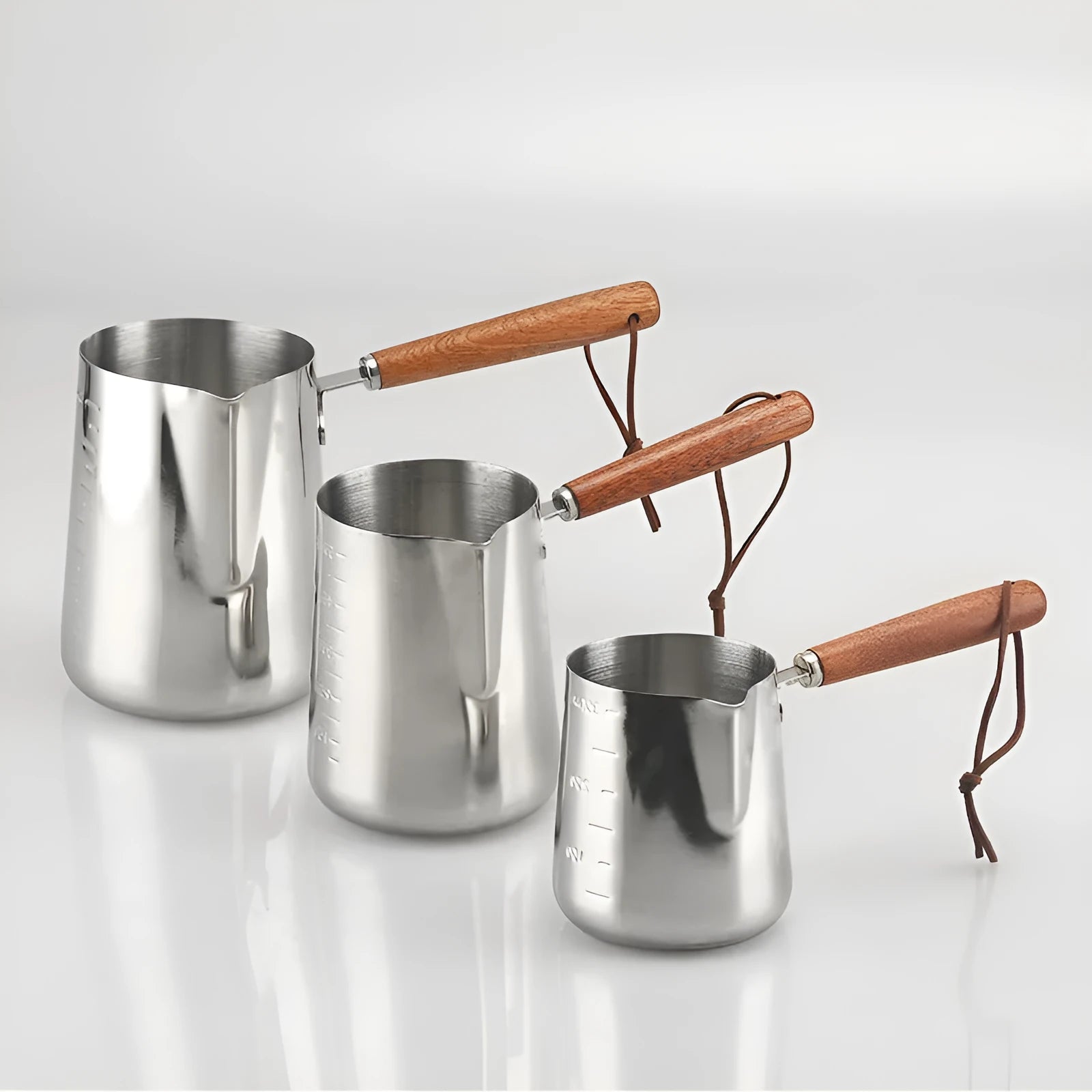 Stainless steel coffee cup with wooden scaled handle showing measurement markings