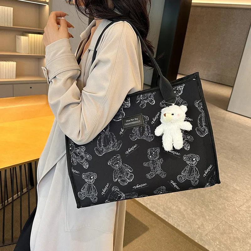 Women's black and white rhombus print canvas tote bag with horizontal square shape and shoulder strap