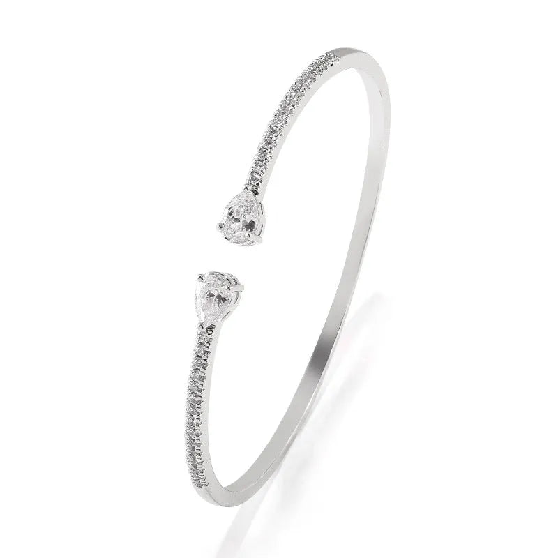 Multi-zircon copper bracelet with zircon inlaid detailing available in white or blue colour