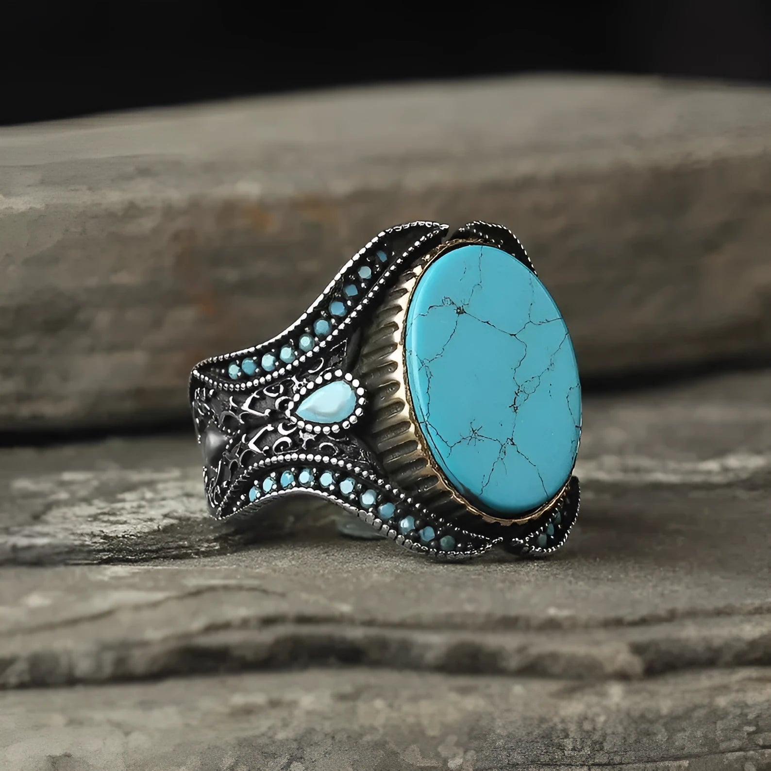 Men's antique silver alloy ring with a round turquoise-coloured stone, shown on a hand.