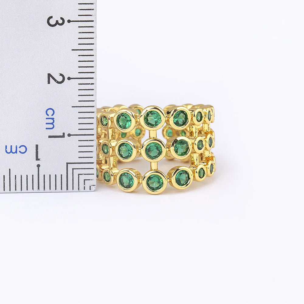 Copper ring with 18K gold plating showing three-layer exaggerated design with zircon stones