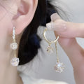Silver women's clip-on drop earrings with a tassel ball and rhinestone ball pendant.