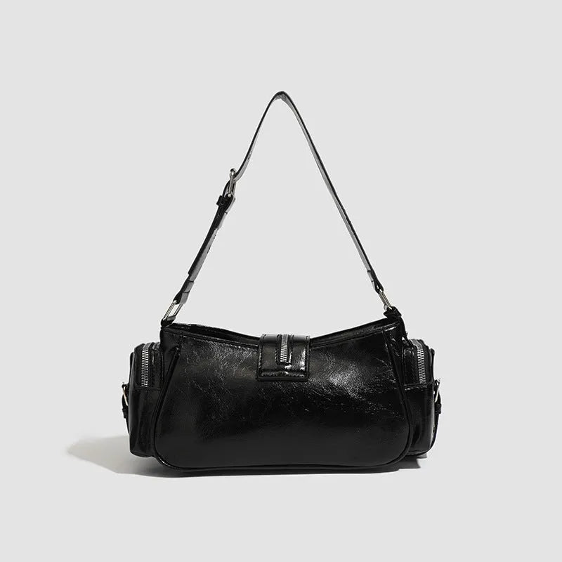 Black retro dumpling-shaped women's shoulder bag with oil wax leather finish and three-dimensional pockets.