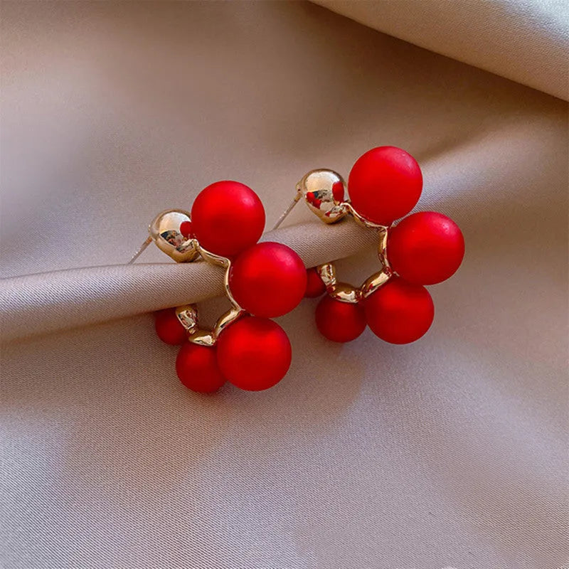 Red alloy earrings with hanging bell charm for women, also available in white