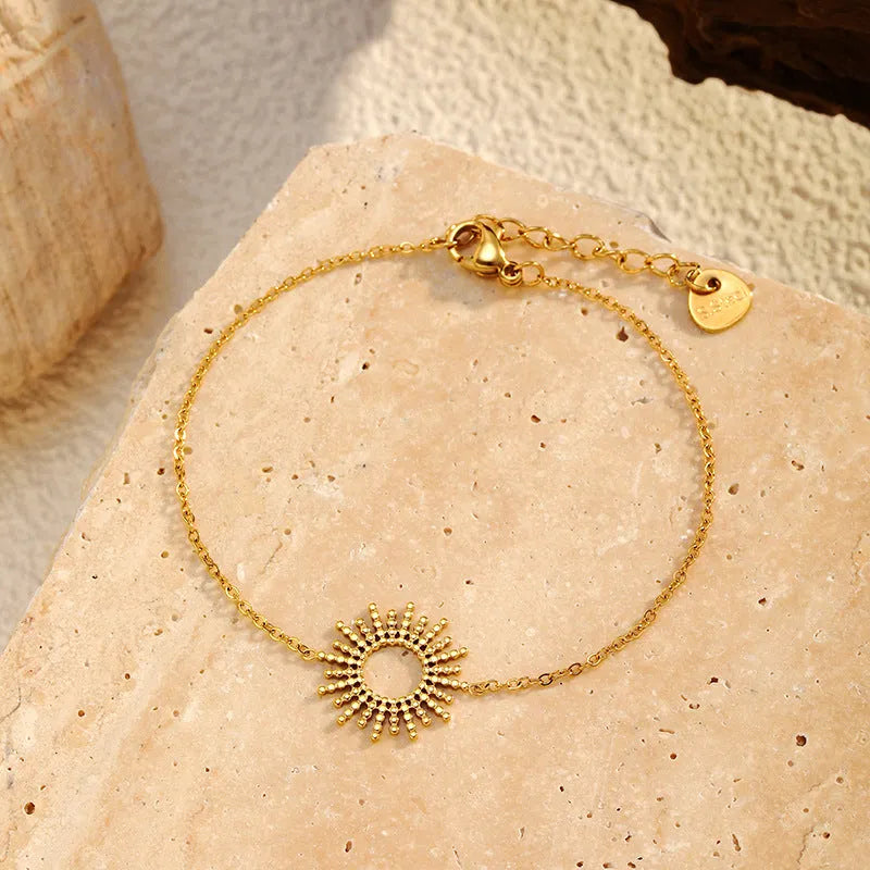 Gold-coloured jewellery set with matching geometry pendant necklace and chain bracelet
