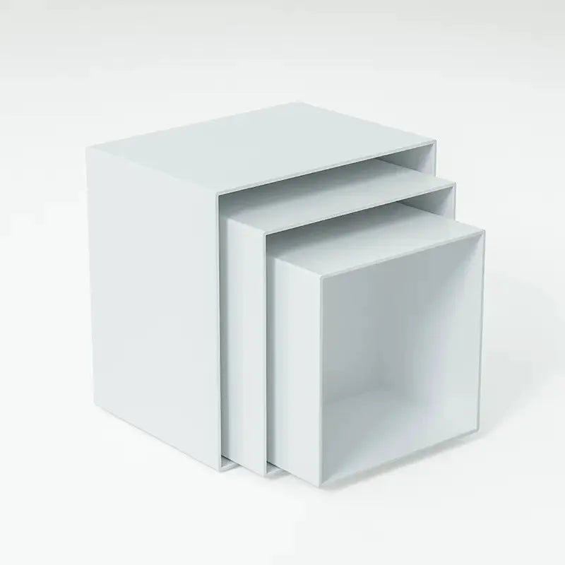 Set of six white plastic cubic dessert display stands in graduated sizes arranged in a row.
