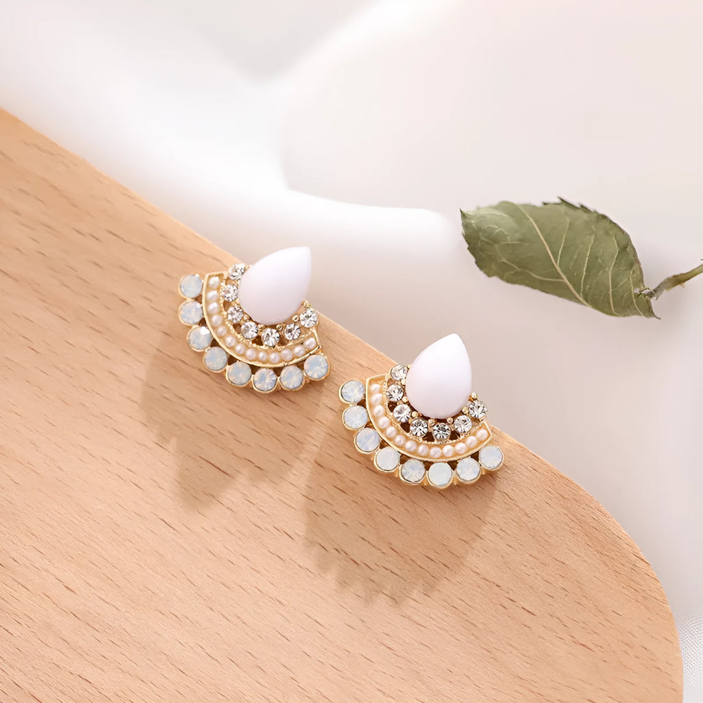 Silver fan-shaped geometric drop earrings with rhinestones on a white background.