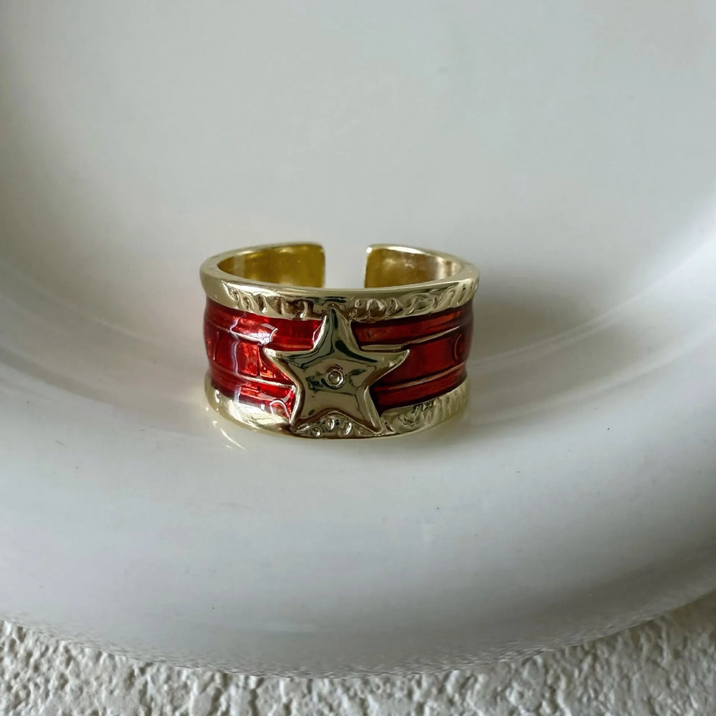 XINGX geometric drop oil ring in distressed electroplated finish on a copper base.