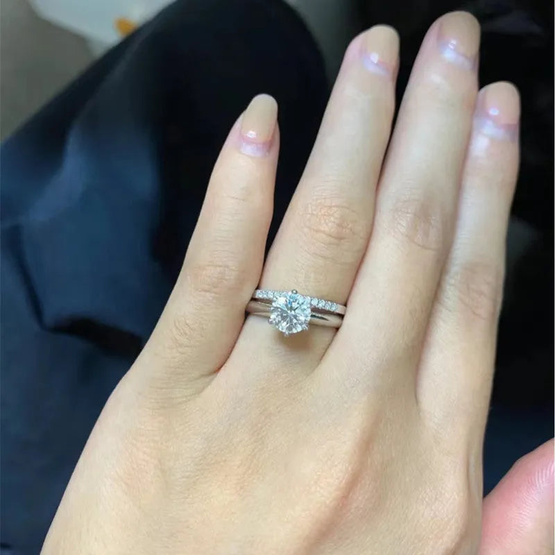 Silver heart-shaped couple rings with dragon phoenix design and adjustable opening showing moissanite stones