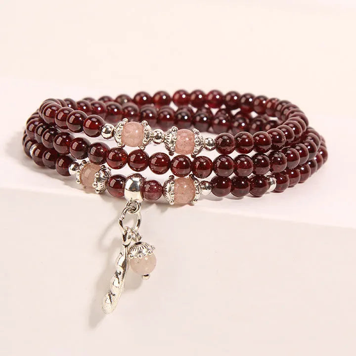 Women's wine red garnet crystal floral bracelet with bohemian design.