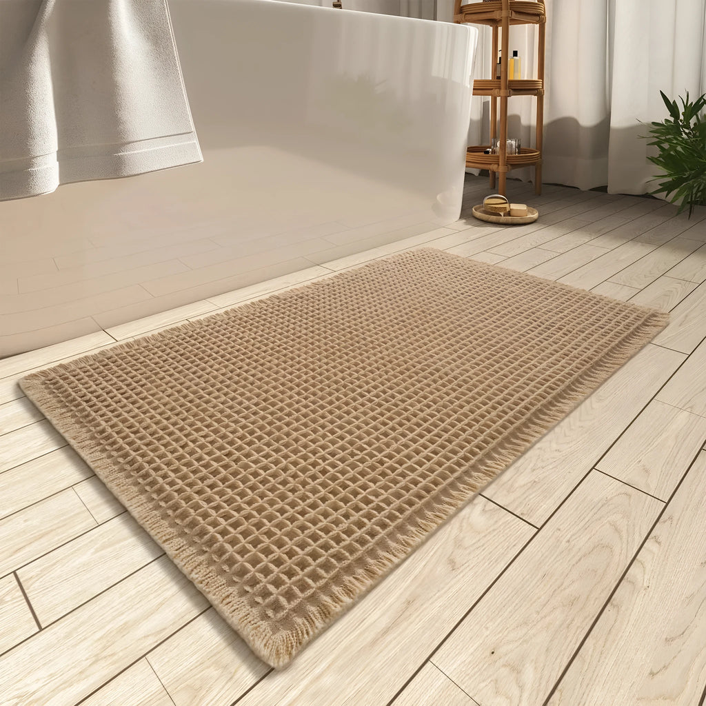 Checkered patterned absorbent bathroom carpet on floor showing non-slip woven base in beige colour.
