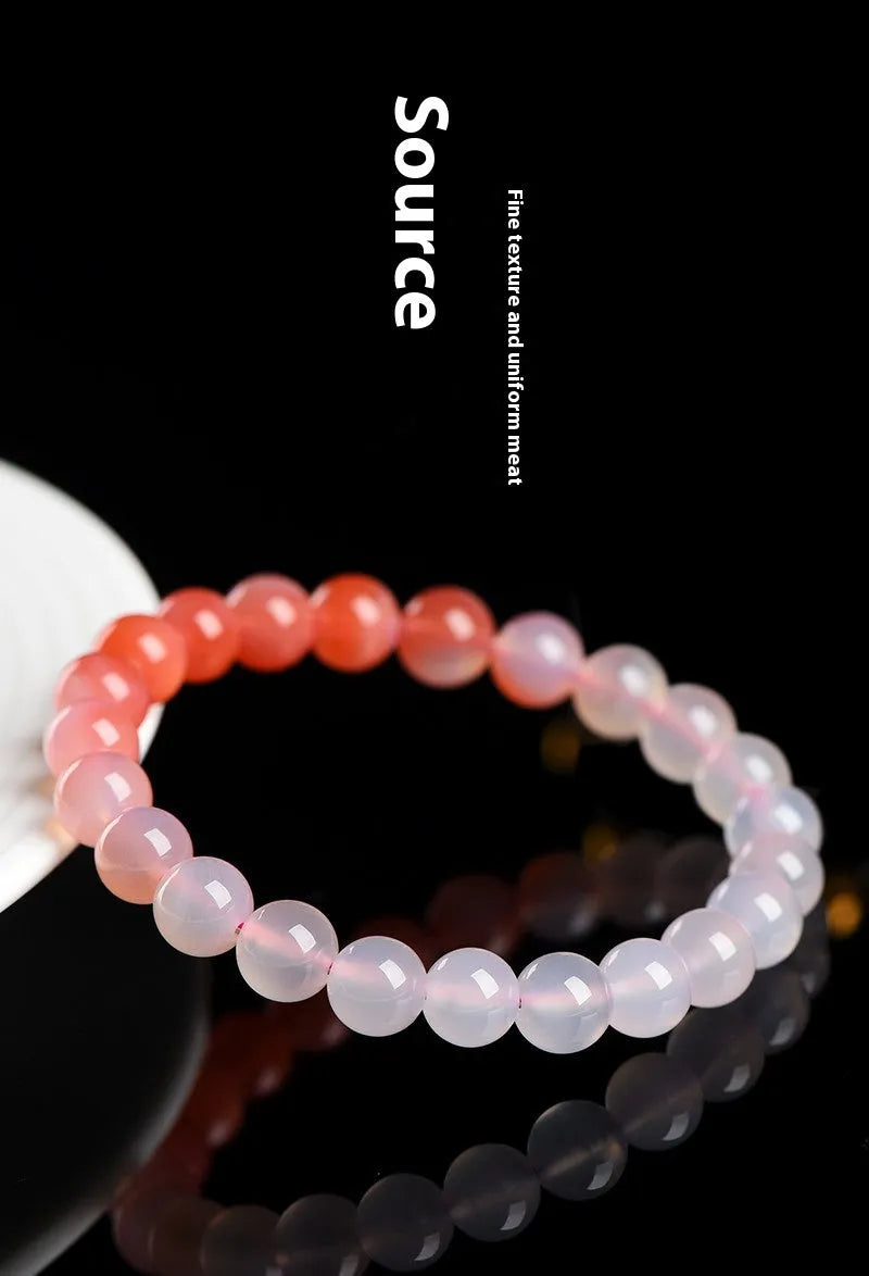 A gradient coloured Yanyuan agate bracelet with polished geometry-shaped beads on a white background.