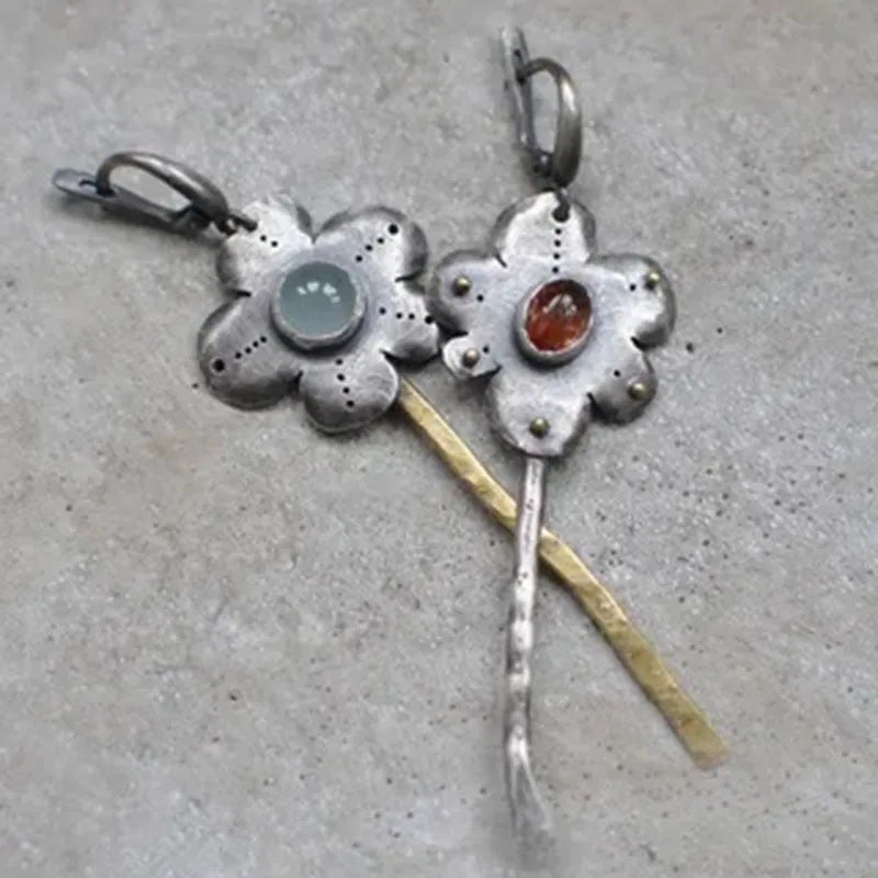 Long retro earrings with two-tone floral geometric design in alloy with electroplated finish.