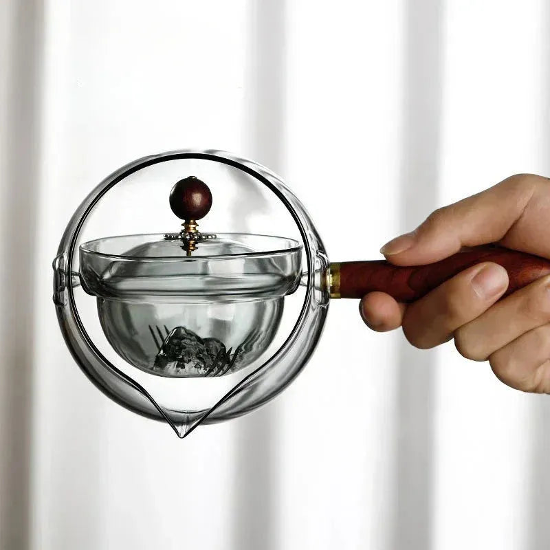 Transparent borosilicate glass teapot with wooden handle and rotation mechanism