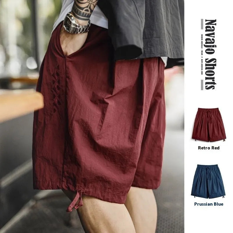 Men's Prussian Blue nylon shorts with embroidered design and elastic waistband