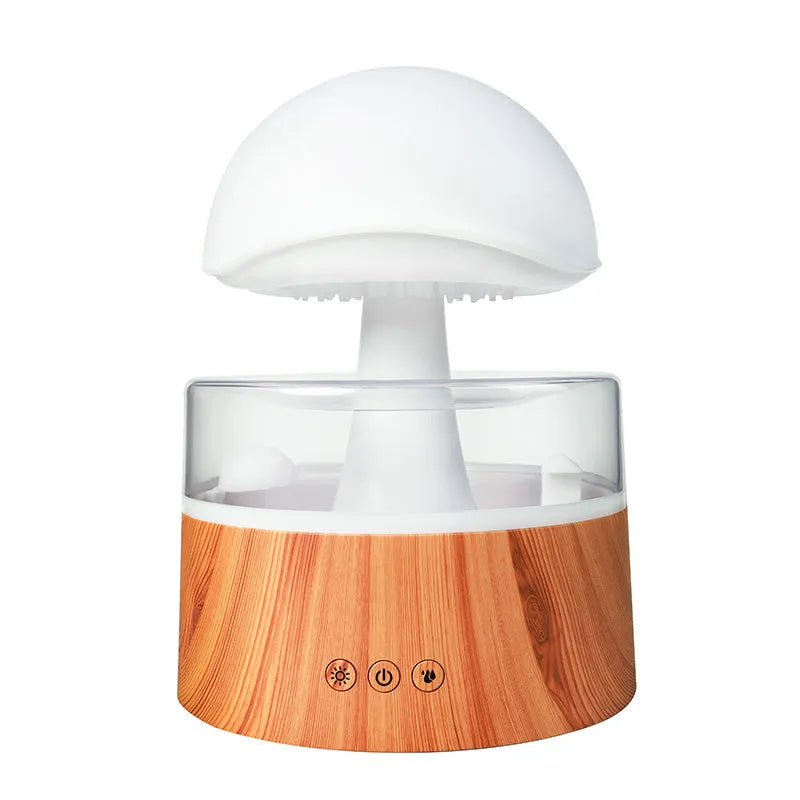 White cloud-shaped humidifier with raindrop simulation and colour-changing lights on wooden surface