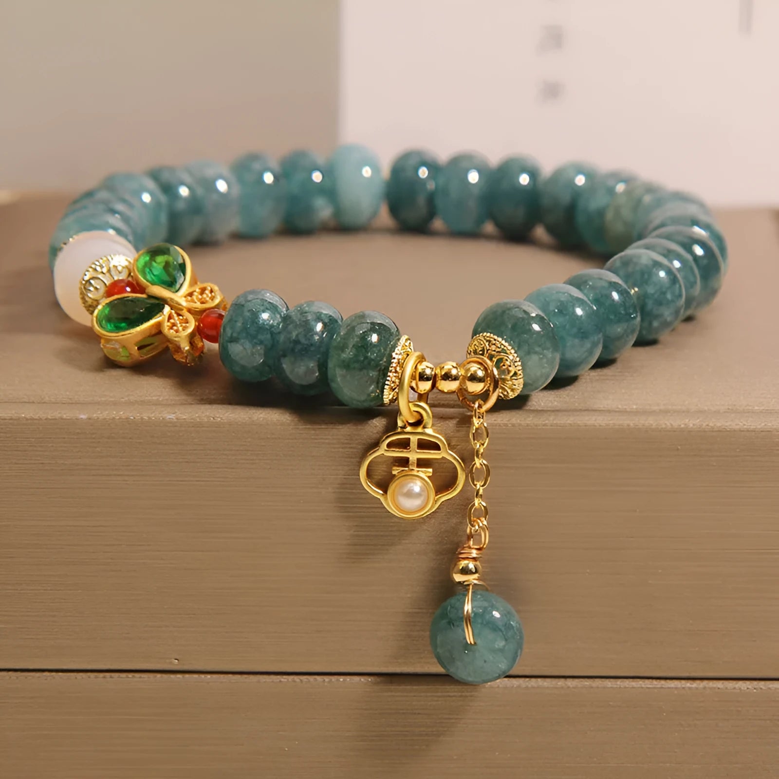 Women's blue water jade abacus bead bracelet with alloy inlay and white agate accents